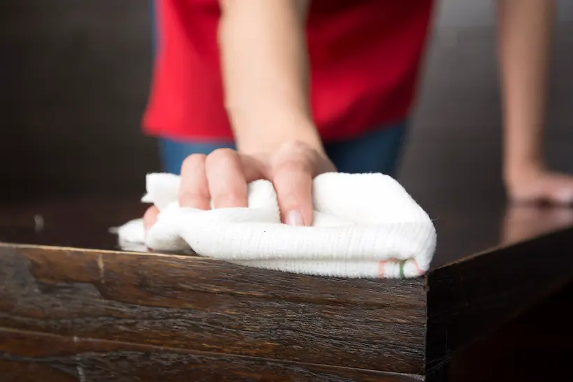 A craftsman applying a natural oil finish.