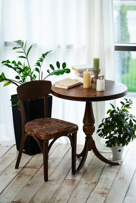 Antique rustic wooden chair and table still in use after decades.
