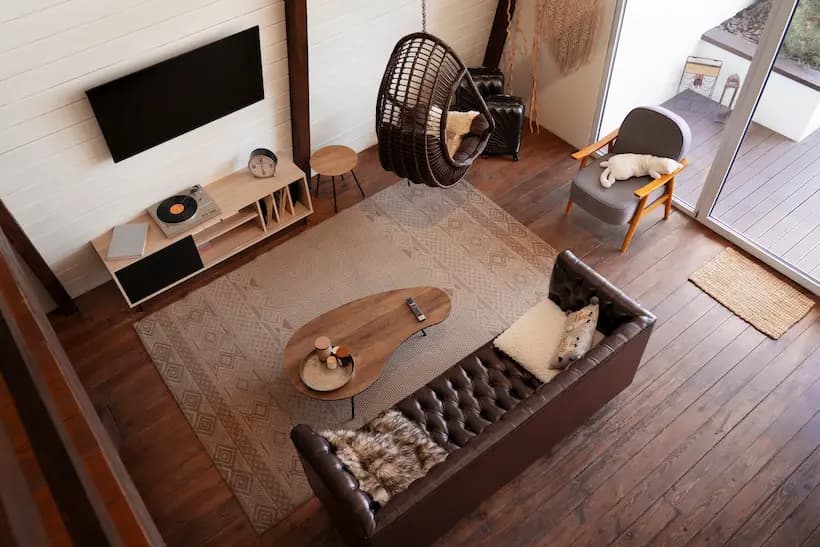 A bright, minimal shot of solid-wood furniture surrounded by natural light. Theme: sustainable living space.